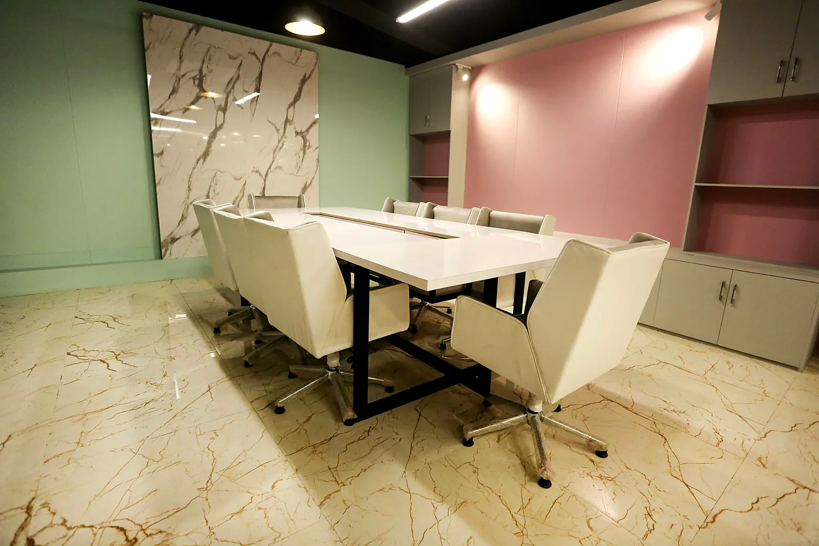 Conference room with white boardroom table for 8 to 10 people at TheWing.pk