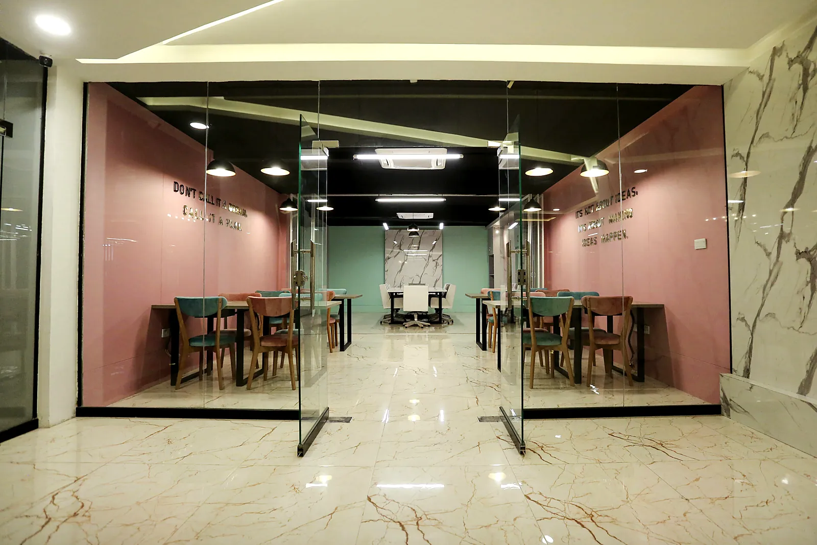 Glass-fronted private team pods along the corridor at TheWing.pk